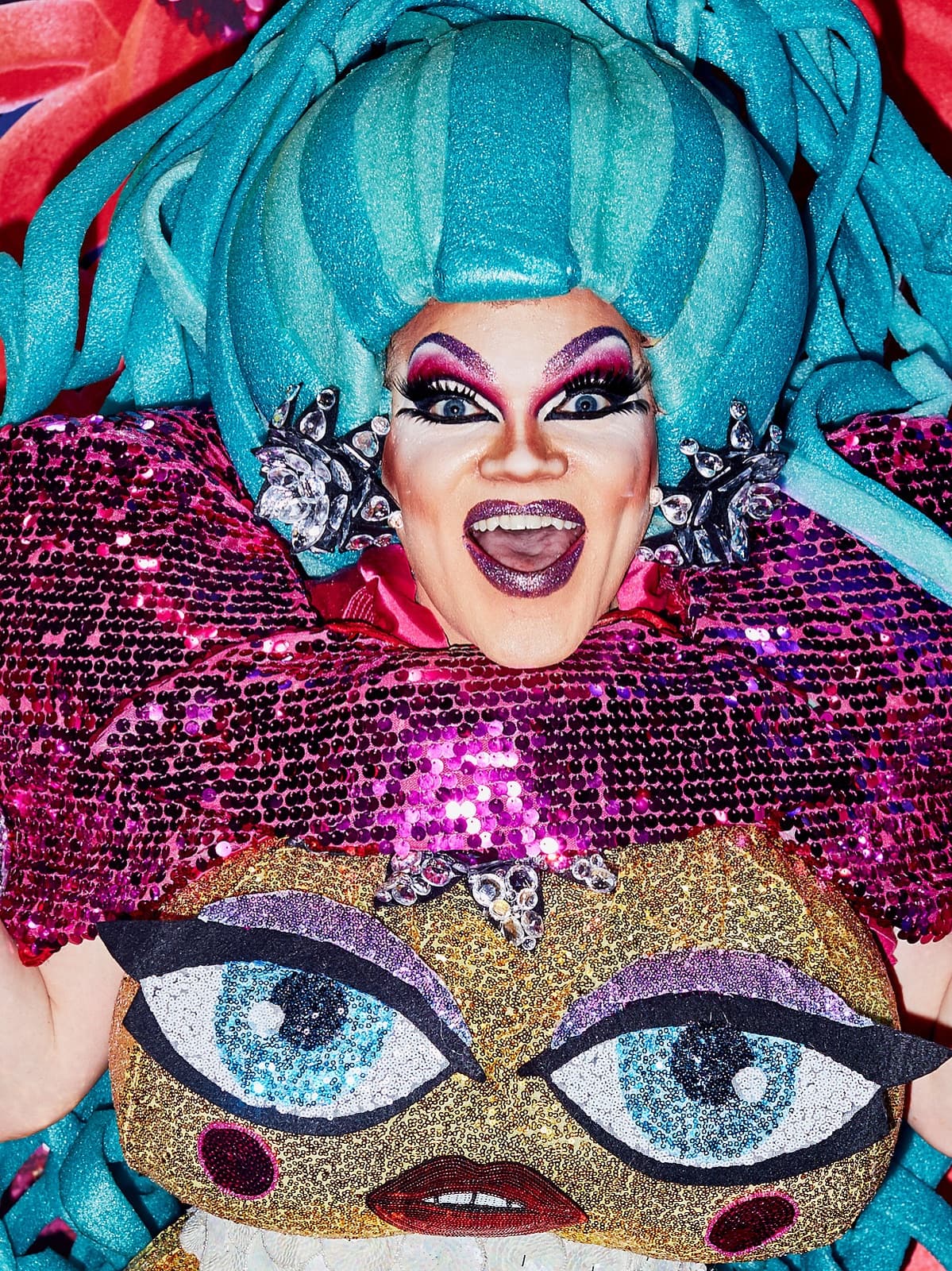 Queen in a sculpted teal wig at RuPaul's DragCon