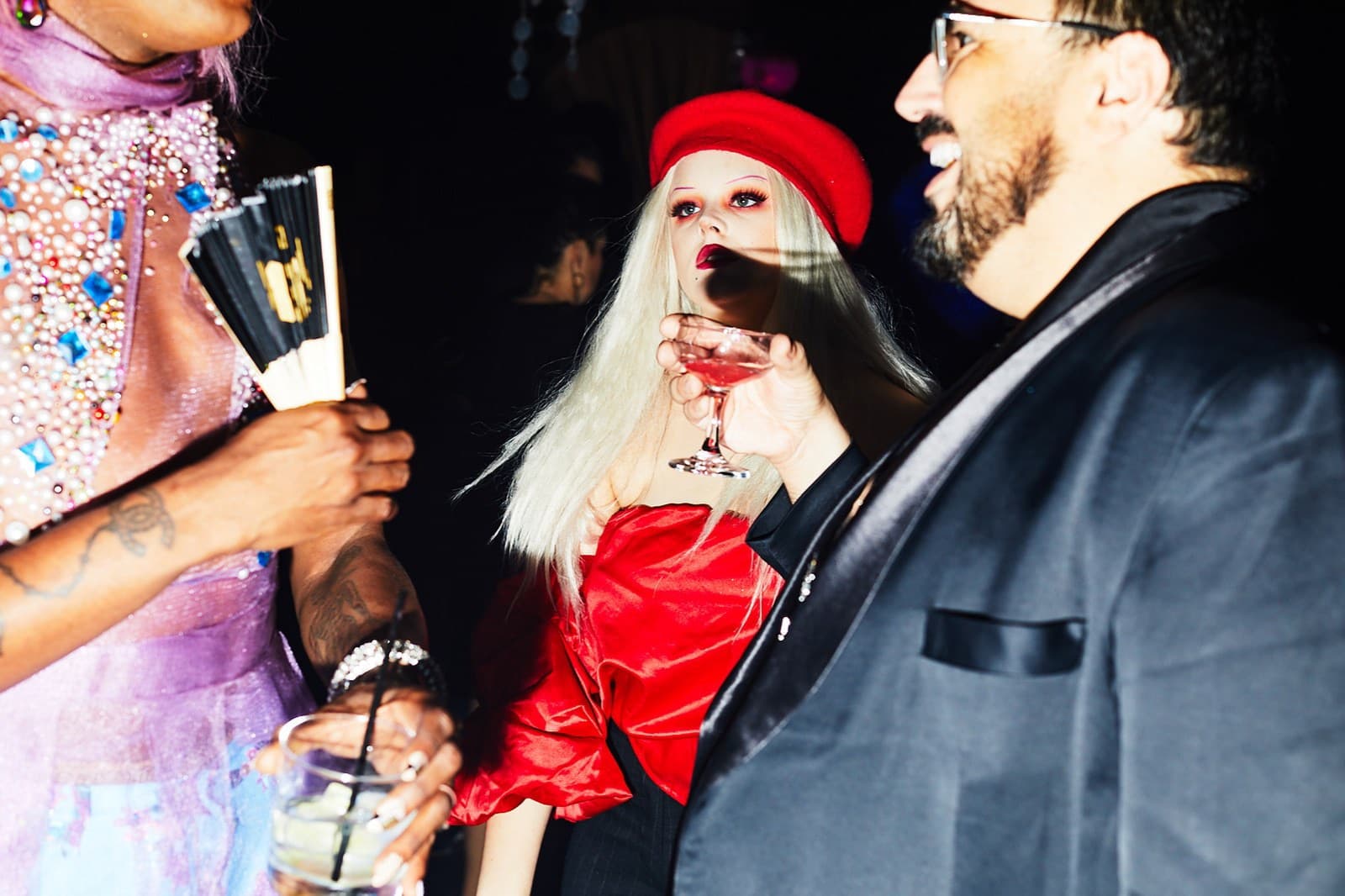 Red beret and a cocktail at a party photographed for The Cut